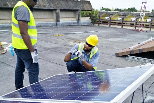 Two students work on a photovoltaic solar power system