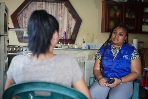 A human trafficking survivor speaks to an IOM staff member