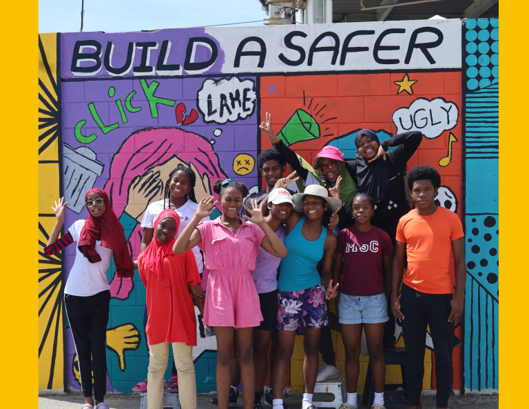 Artivism Group Shot of Child Artists standing in front of the mural they painted